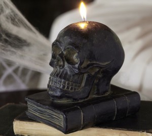 Skull candle on old books for Halloween decor