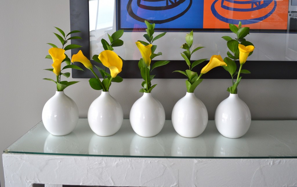 White vases with yellow calla lillies