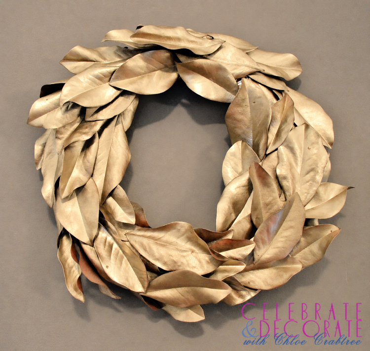 DIY wreath made from overlapping magnolia leaves painted in warm metallic gold.
