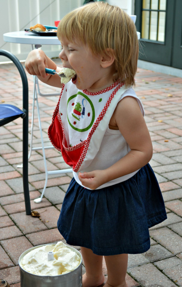 Little girl eating a big spoonful of ice cream
