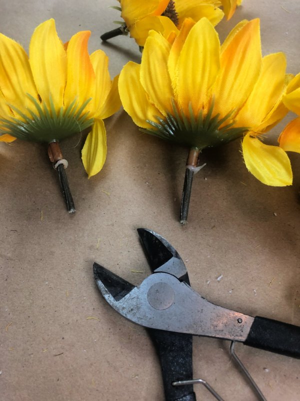 Faux sunflowers with the stems cut to one inch