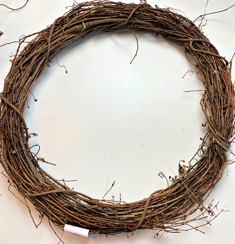 Large round grapevine wreath base made from intertwined natural brown vines.