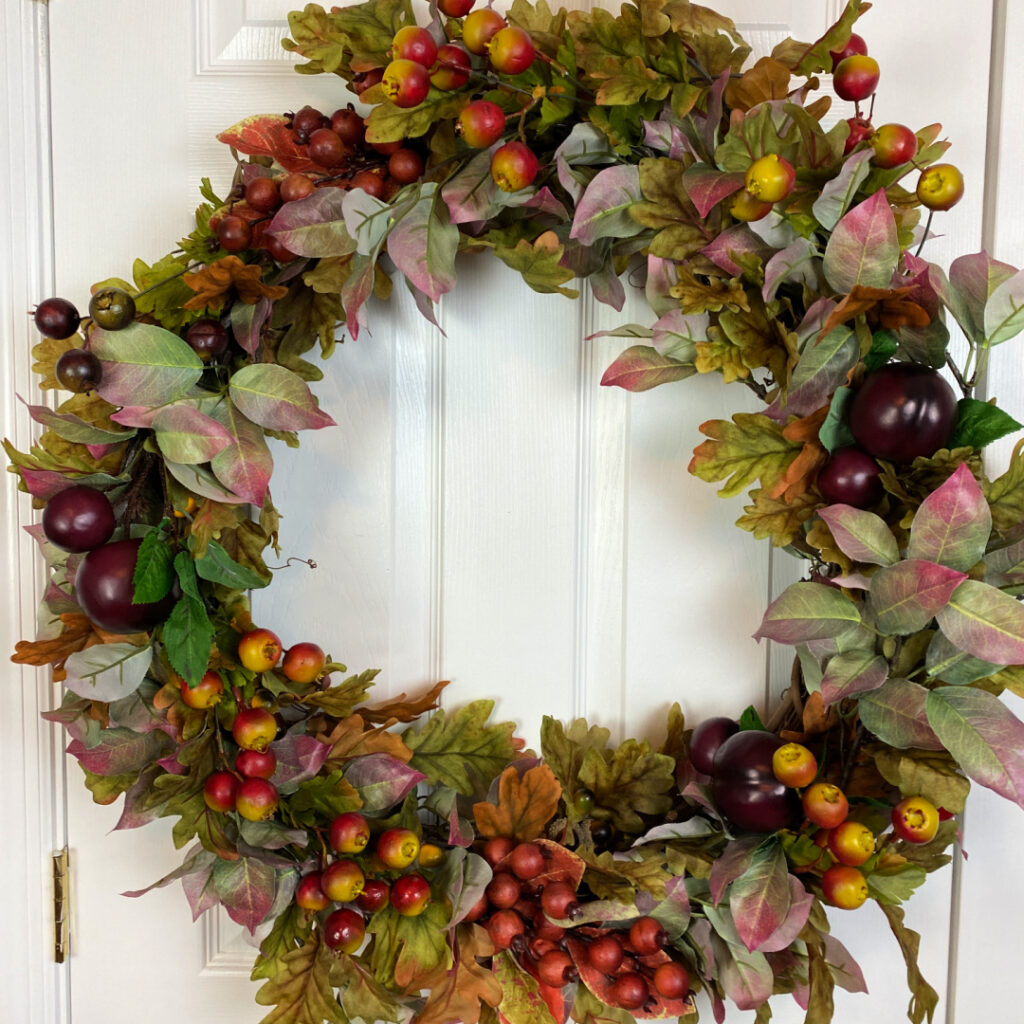 Lush fall wreath with faux leaves and faux fruits and berries