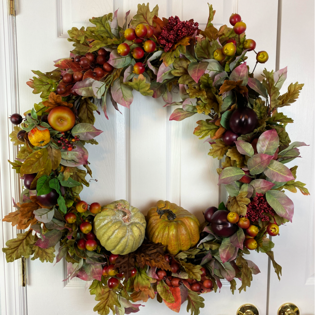 Fall wreath with leaves, fruits and pumpkins