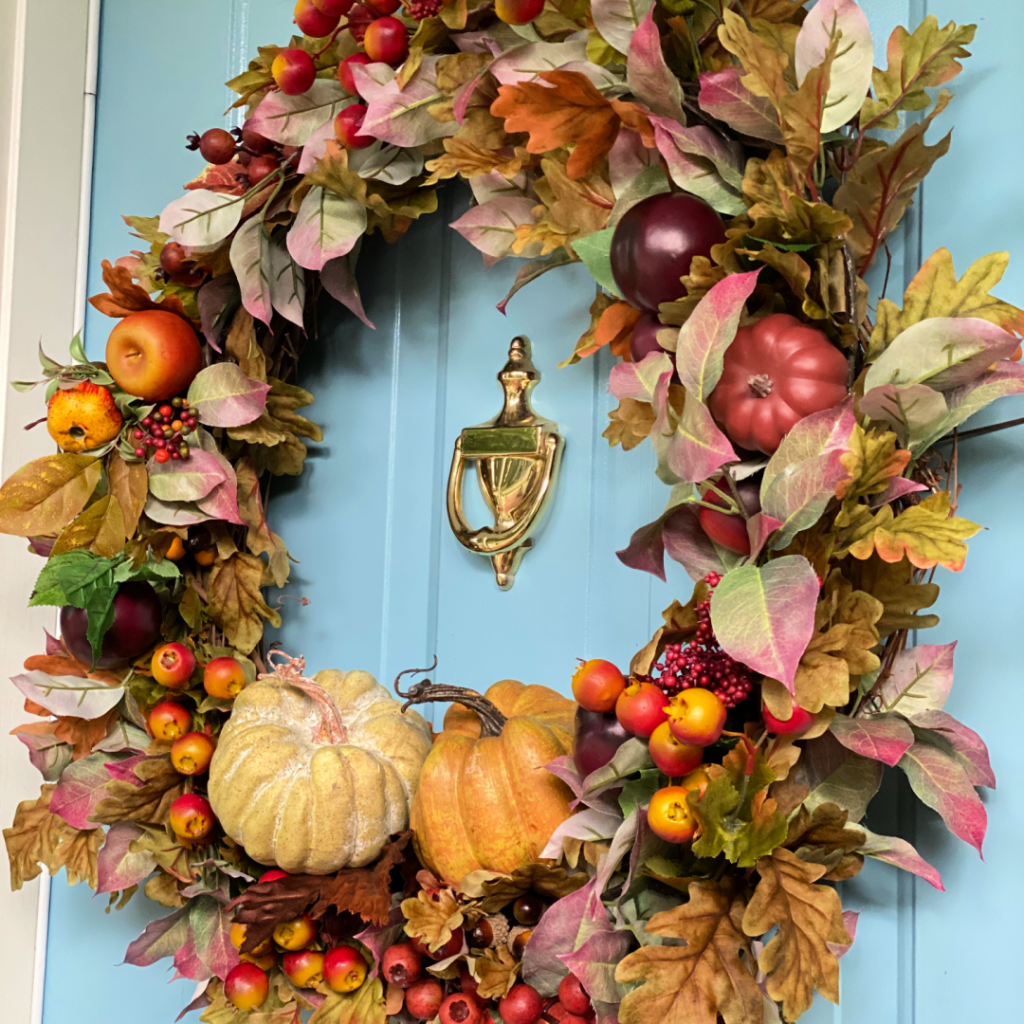 Fall wreath with leaves, fruits and pumpkins