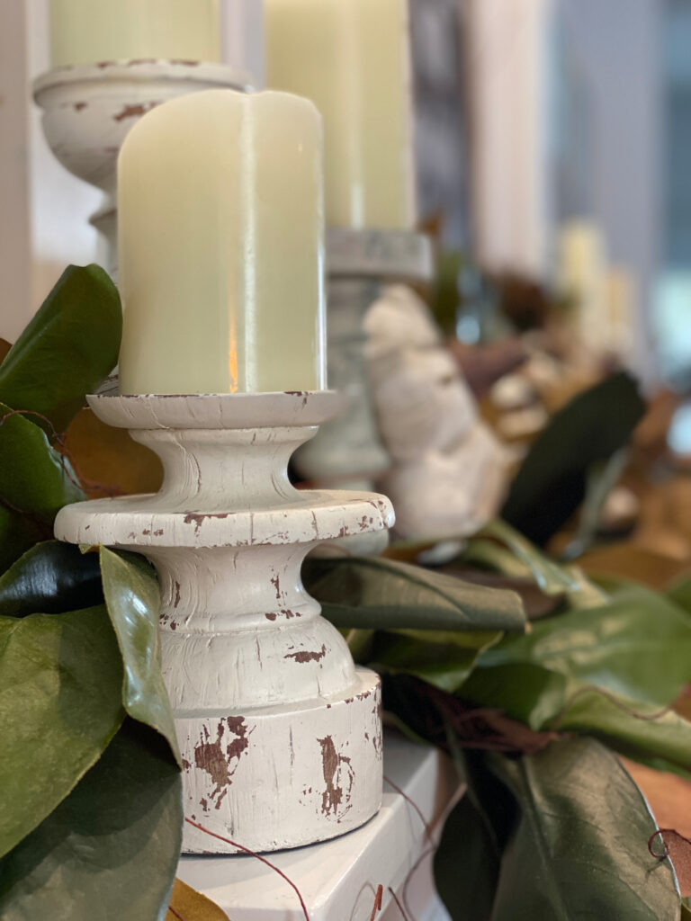 white distressed candleholder with a faux white candle