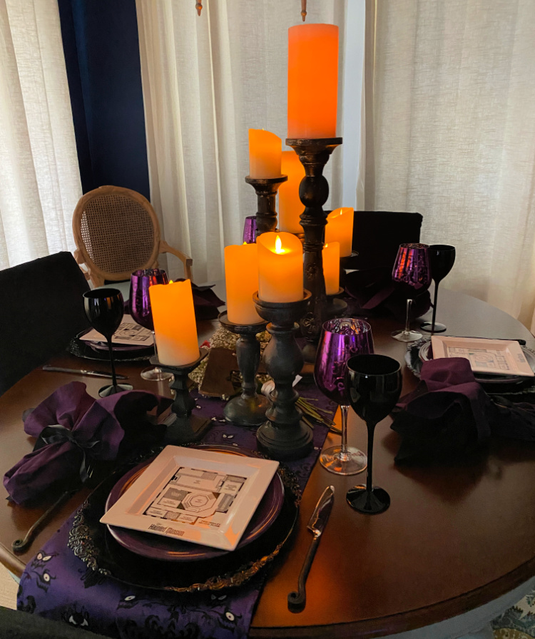 Glowing orange candles over a halloween tablescape