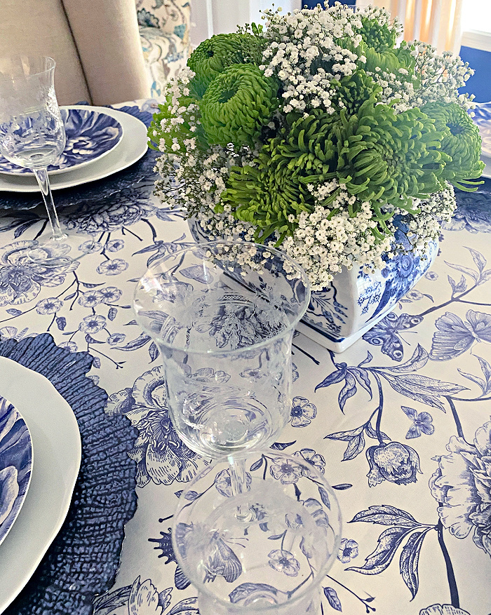 Blue and white floral tablecloth with a blue and white table setting and bohemian crystal stemware. 

