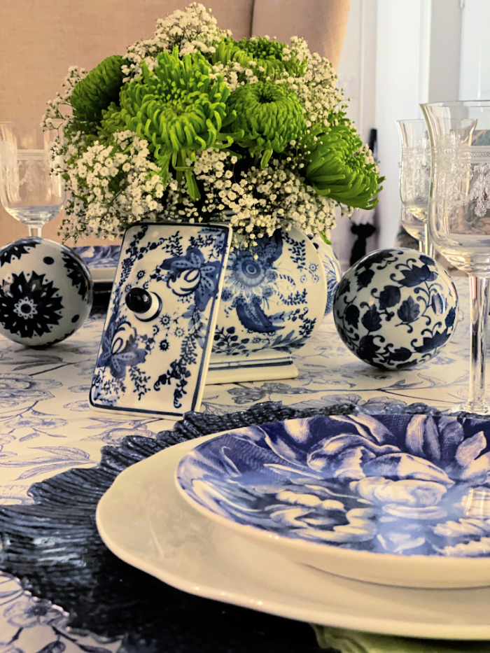 Blue and white chinoiserie tablescape with bright green chrysanthemums for a centerpiece
 