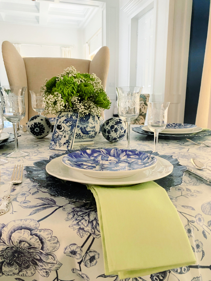 View of a blue and white tablescape set for a late summer dinner with chinoiserie vibe 