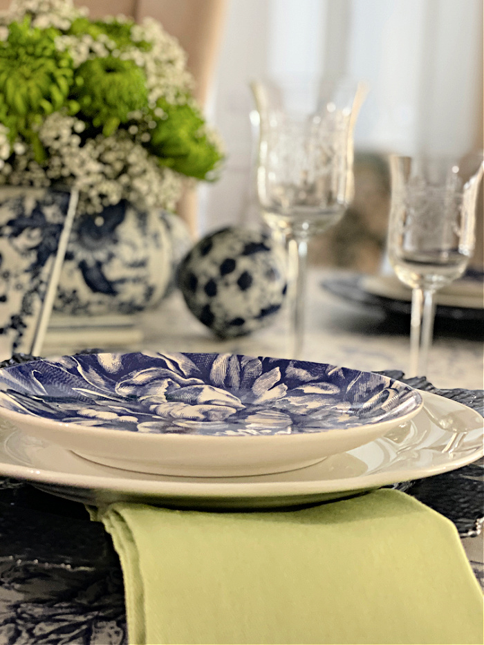Side view of a blue and white table setting with crystal stemware