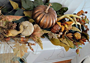 golden pumpkin and antler display on a white mantel