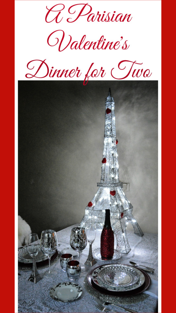 A Parisian themed Valentine's Dinner with light up eiffel tower with red hearts on it and silver place settings 