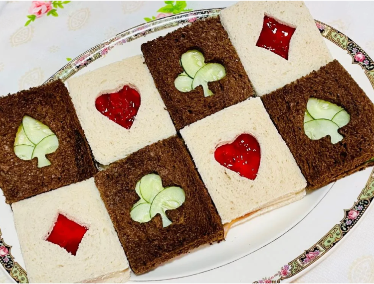 Finger sandwiches or tea sandwiches on white and rye breads with hearts, diamonds spades and clover shapes, perfect for a card party