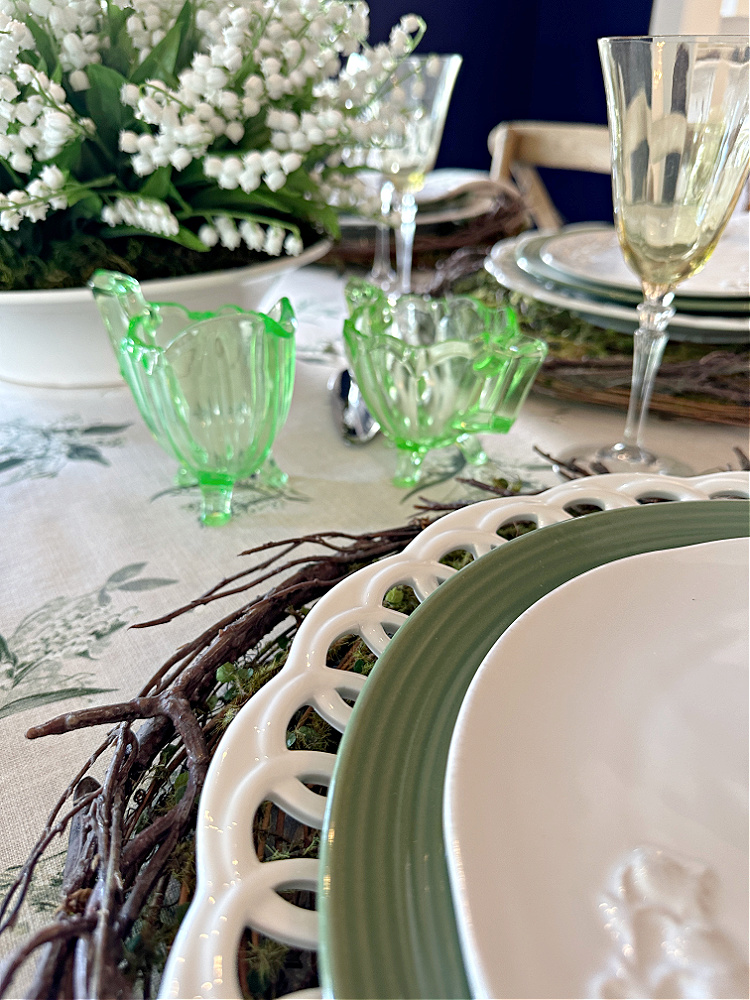 Antique green glass creamer and sugar bowl on a green and white spring tablescape. 