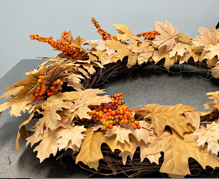 Golden maple leaf wreath with bittersweet berry clusters.