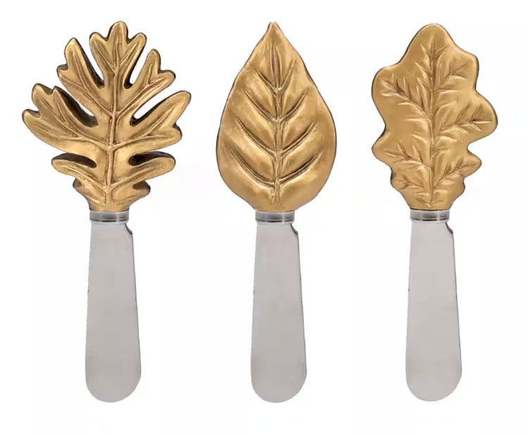 Three cheese knives with gold leaf handles.